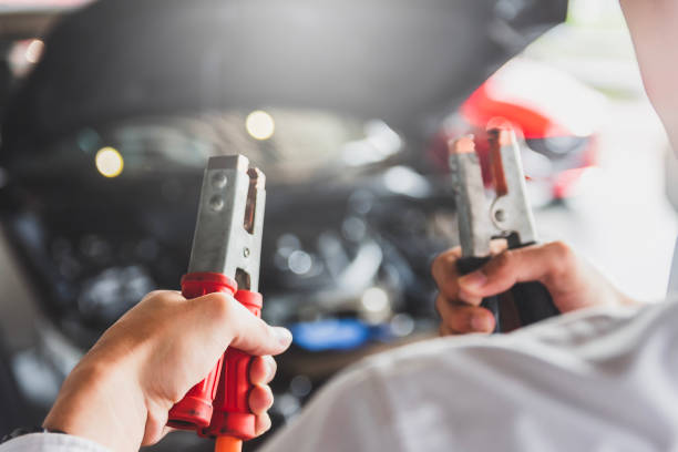 man inspection holding jumper cables for charger battery service maintenance of industrial to engine repair.in factory transport automobile automotive image - usa hop wire stem imagens e fotografias de stock