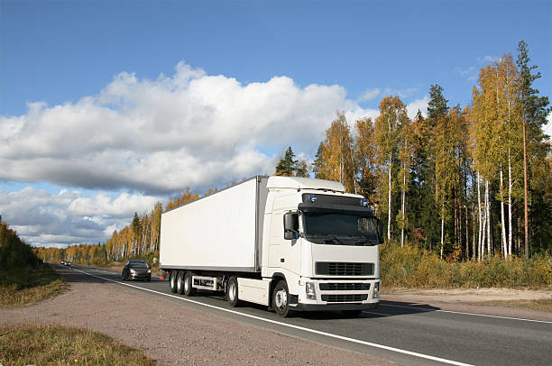 istock White truck driving down the highway in Autumn 118428799