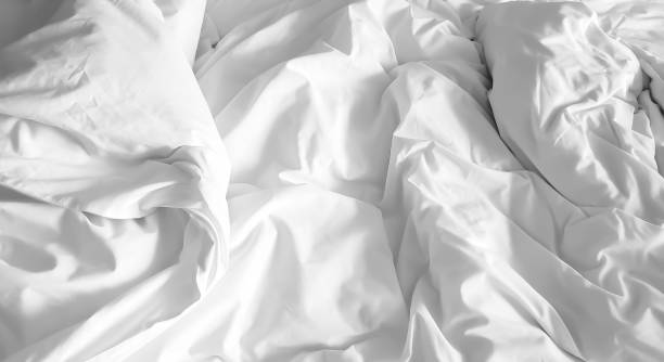 istock Closeup on soft white and crumpled blanket in bedroom for Valentine backdrop. 1184288214