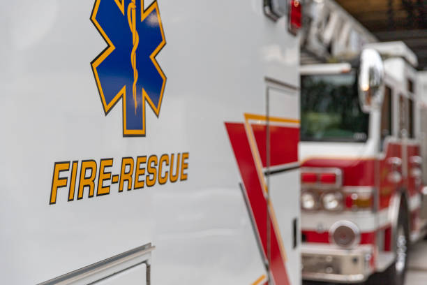 Ambulance parked in front of fire truck Side view of an ambulance rescue vehicle parking in front of a fire engine new big tube stock pictures, royalty-free photos & images