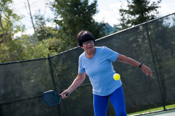 istock Active senior playing pickleball at a public court 1184294019