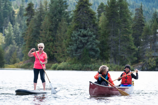 istock Active senior women paddling on the lake 1184294638