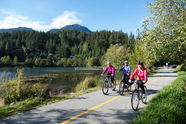 Active seniors cycling on a paved trail near the lake