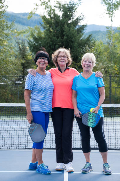 istock Active seniors bonding at the tennis court 1184294816