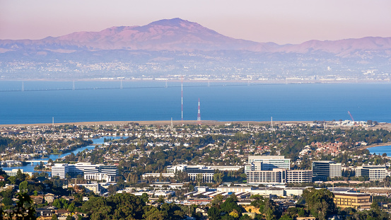 Aerial view of San Carlos and Redwood Shores; East Bay and Mount Diablo in the background; pollution and smoke visible in the air