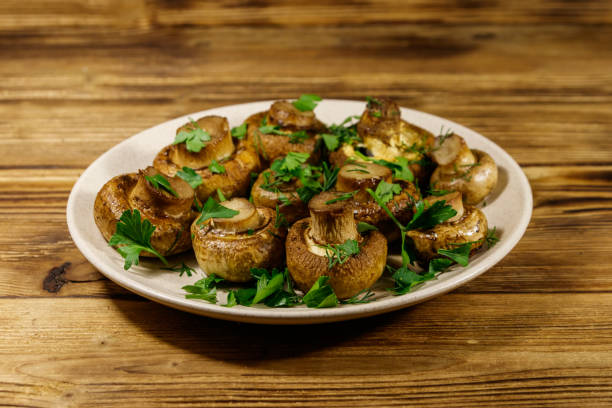 istock Baked mushrooms in plate on wooden table 1184300205