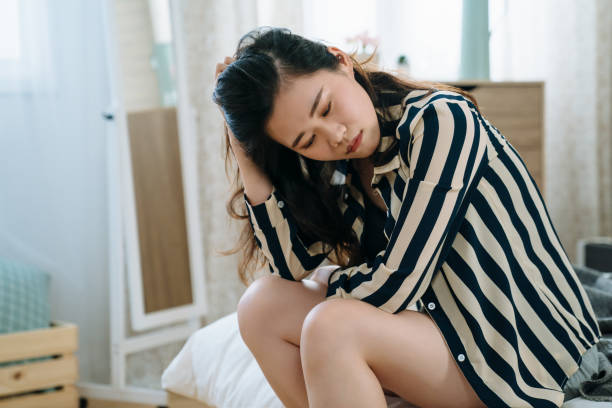 istock woman suffering from depression on bed 1184303531