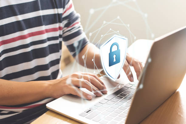 istock Close-up image of male hands using computer laptop with icon graphic cyber security network of connected devices and personal data information 1184303835