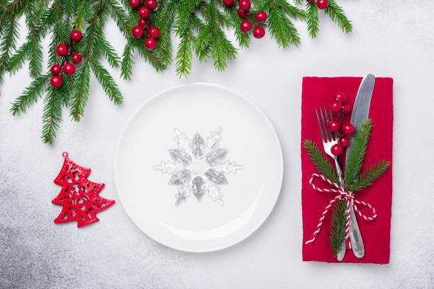 istock Christmas table setting with gifts and fir tree branch on stone background. Top view. Copy space 1184305718