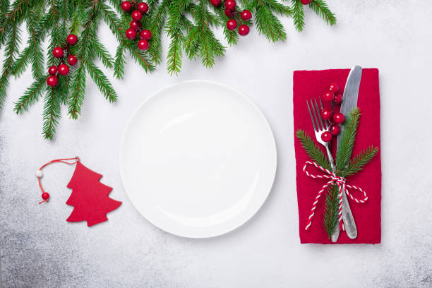 istock Christmas table setting with gifts and fir tree branch on stone background. Top view. Copy space 1184305731