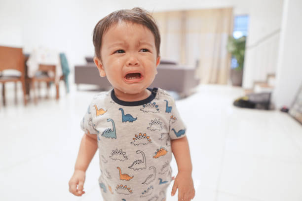 Close-up photo of an 18 months old boy having a meltdown and crying inconsolably. stock photo
