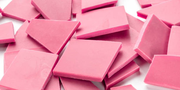 istock A panorama of ruby chocolate slices, a heap on a white background 1184305902