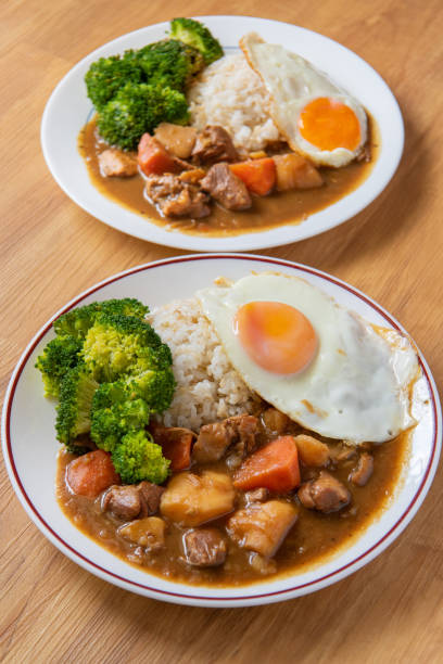 Chicken curry Rice on wooden background ( Poached egg, Potato, enoki mushroom, onion, broccoli, Japanese style,)