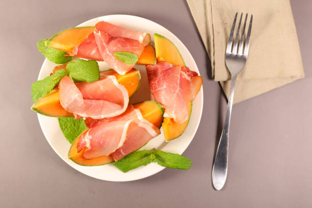 istock melon and prosciutto ham and basil ,top view 1184316089