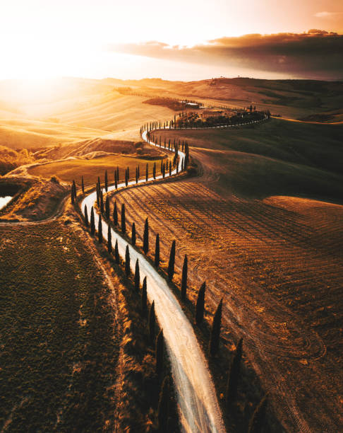 winding road in italy winding road in italy crete senesi stock pictures, royalty-free photos & images