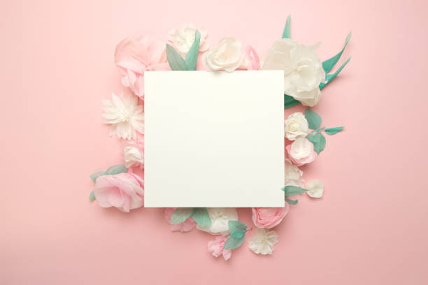 istock Greeting card with paper flowers on rose background. 1184317115