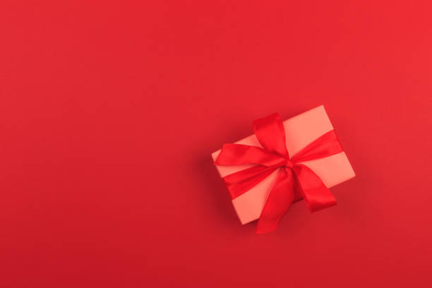istock Gift box with ribbon and bow on color background and space for text. Top view 1184320712
