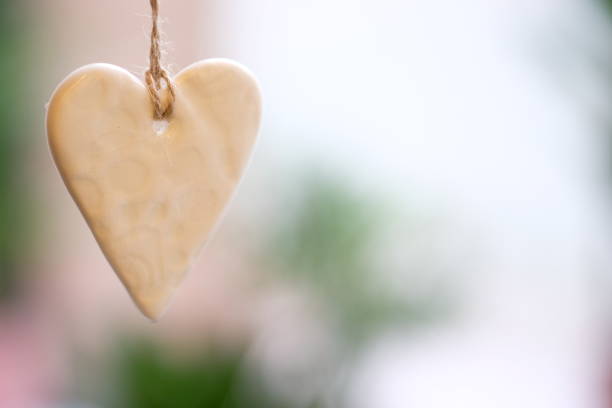 istock Christmas decor ceramic heart, ornament hanging on sacking threads 1184320931