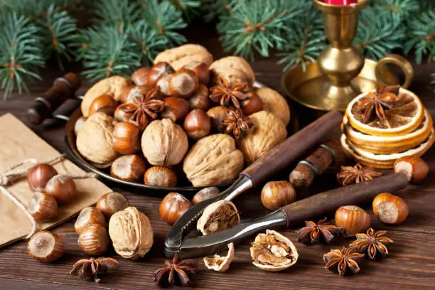Christmas still life  with spices, nuts and dried oranges on wooden  background