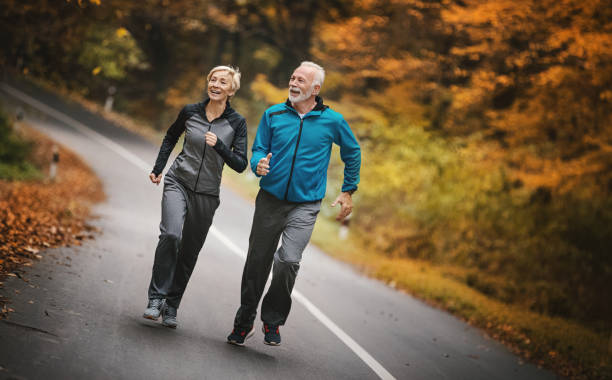 istock Senior couple jogging in a forest. 1184321246