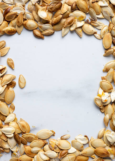 istock roast Pumpkin seeds background, flat lay 1184321390