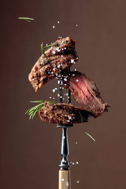 istock Grilled ribeye beef steak with rosemary on a brown background. 1184321986