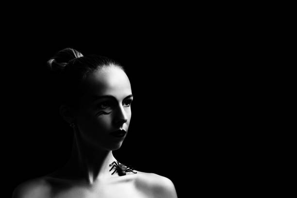 istock Woman with spider on black close-up. 1184324089