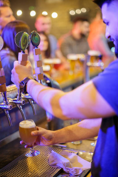 istock Pulling tap and pouring a glass of craft beer 1184325350