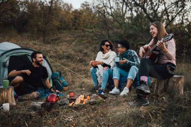 istock Young friends laughing, hanging out at campsite 1184327507