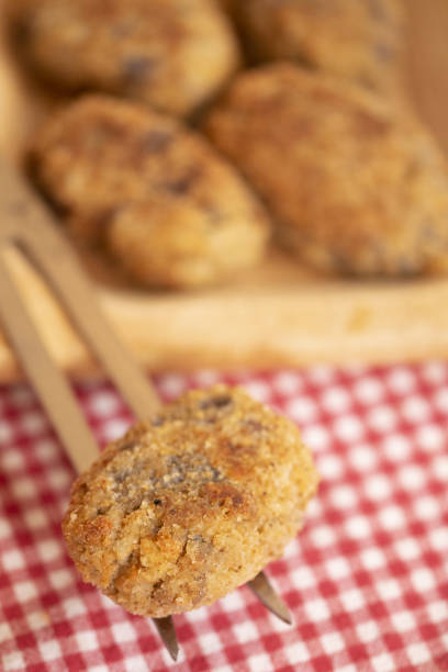fried homemade eggplant meatbals on a carving fork