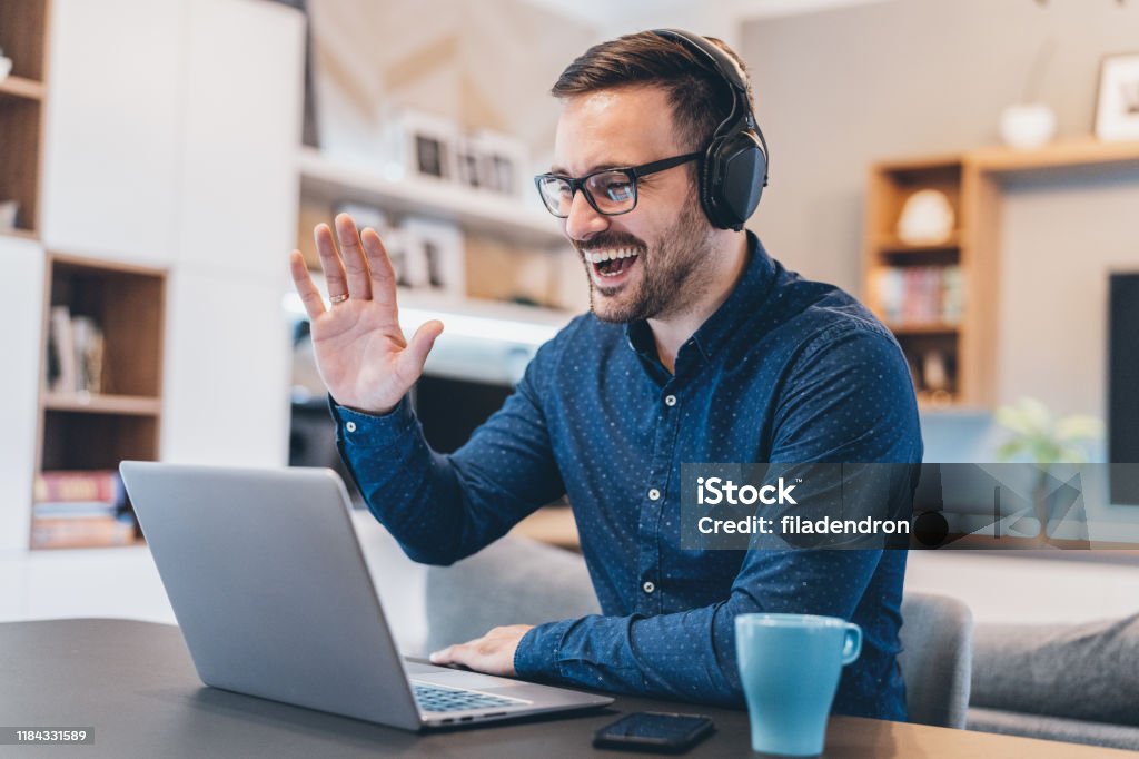Business Video Conference Handsome businessman having Video Conference at home Internet Stock Photo