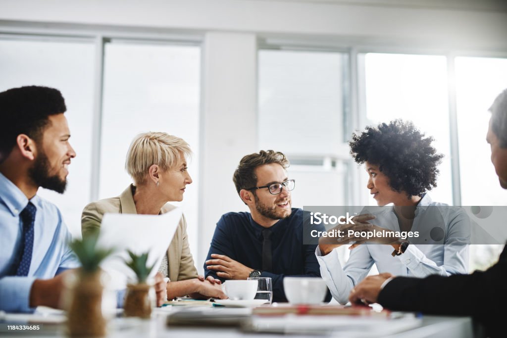 Always brainstorming Cropped shot of a diverse group of businesspeople sitting together and having a meeting in the office Teamwork Stock Photo