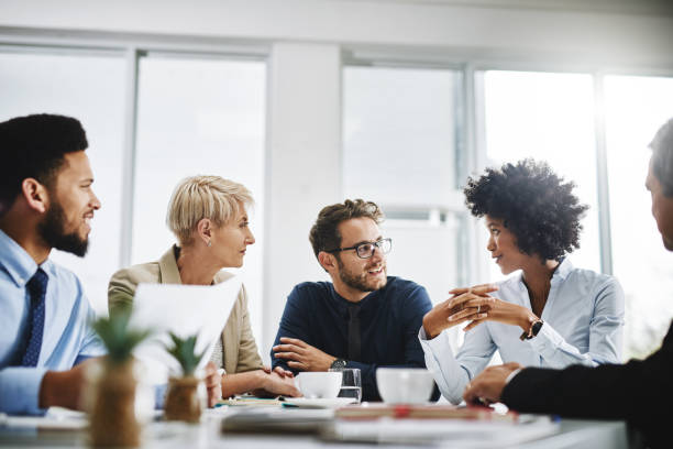 Always brainstorming Cropped shot of a diverse group of businesspeople sitting together and having a meeting in the office respect photos stock pictures, royalty-free photos & images