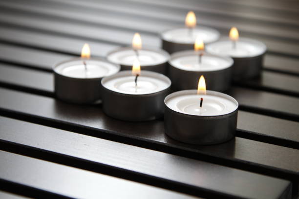 istock Tea lights on a wooden bench 1184336195
