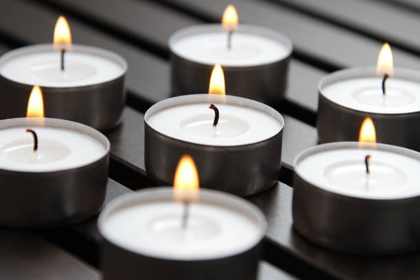istock Tea lights on a wooden bench 1184336625