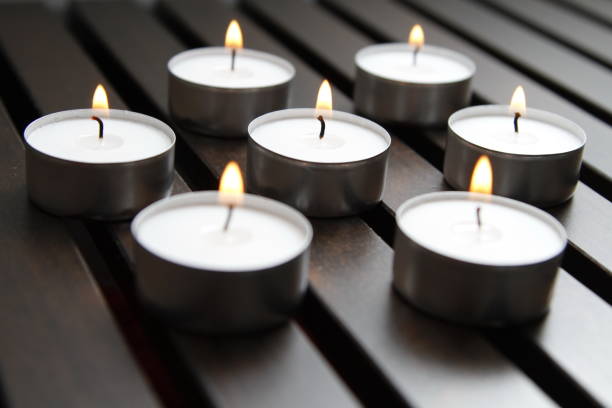 istock Tea lights on a wooden bench 1184336686