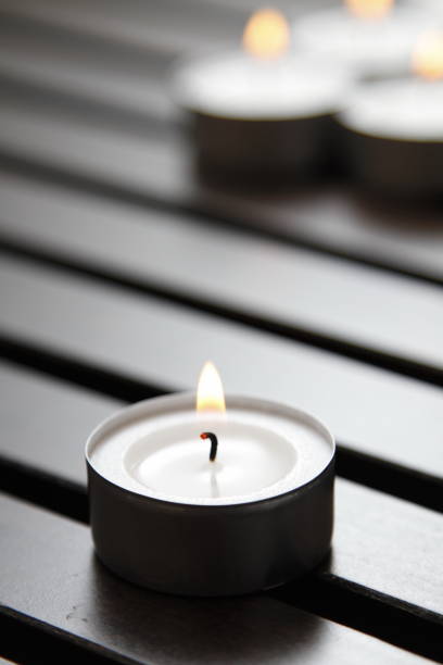 istock Tea lights on a wooden bench 1184336753
