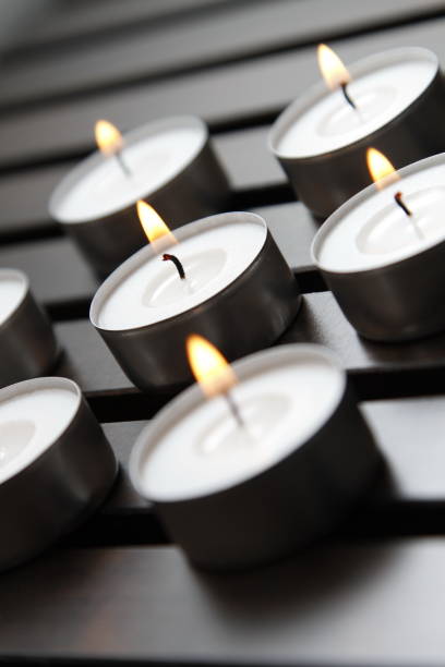 istock Tea lights on a wooden bench 1184337304