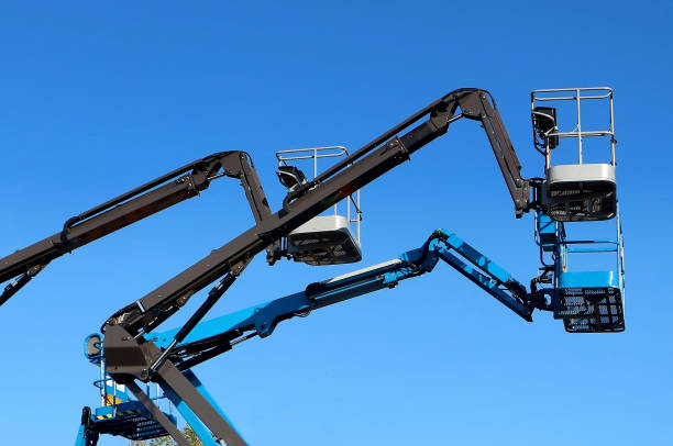istock Black and blue aerial work platforms of cherry picker against blue sky 1184337347