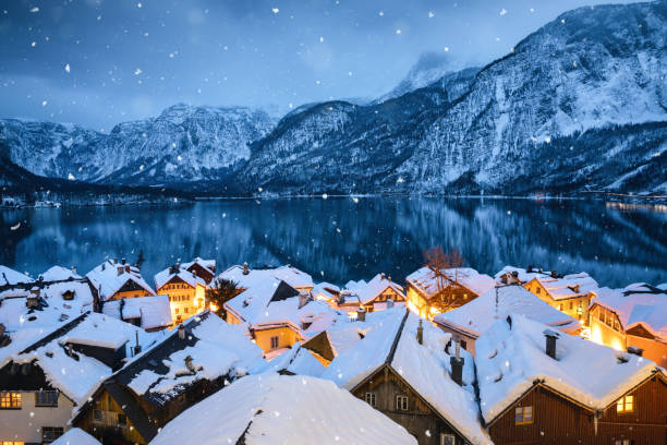 Hallstatt Village In Snow Tranquil winter evening in idyllic Austrian village Hallstatt. austrian culture stock pictures, royalty-free photos & images