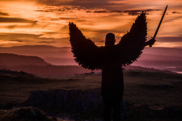 istock Black Winged Warrior Angel at dawn 1184339275