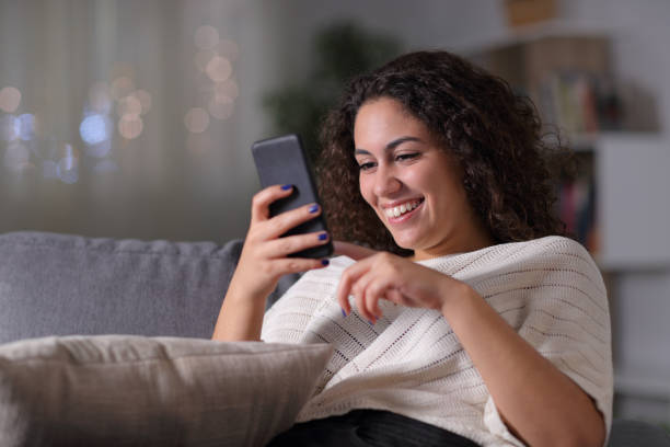 istock Happy arab woman using smart phone in the night 1184340022