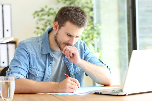 istock Pensive entrepreneur handwriting at office 1184340712