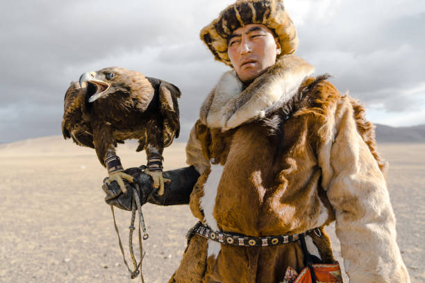 istock Portrait of eagle hunter standing in desert in Mongolia 1184341172