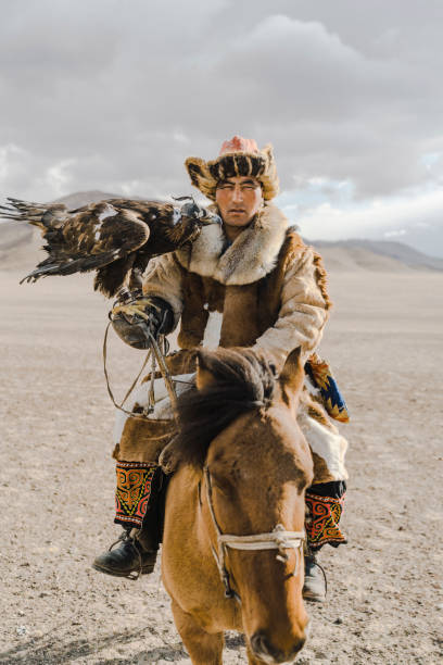 istock Portrait of eagle hunter on horse in desert in Mongolia 1184341240