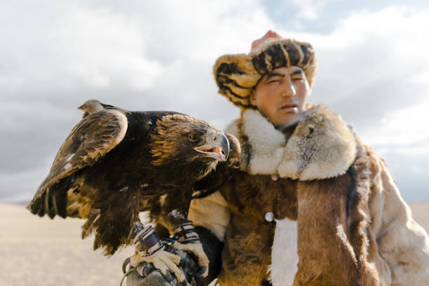 istock Portrait of eagle hunter standing in desert in Mongolia 1184341283