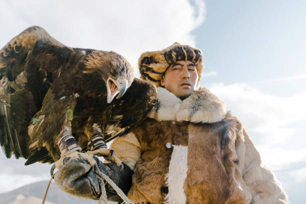 istock Portrait of eagle hunter standing in desert in Mongolia 1184341297