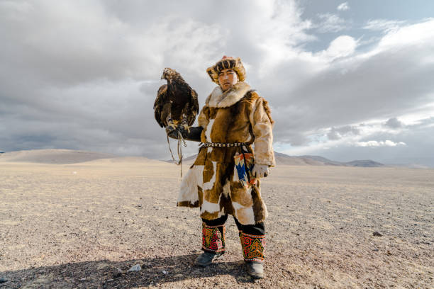 istock Portrait of eagle hunter standing in desert in Mongolia 1184341304