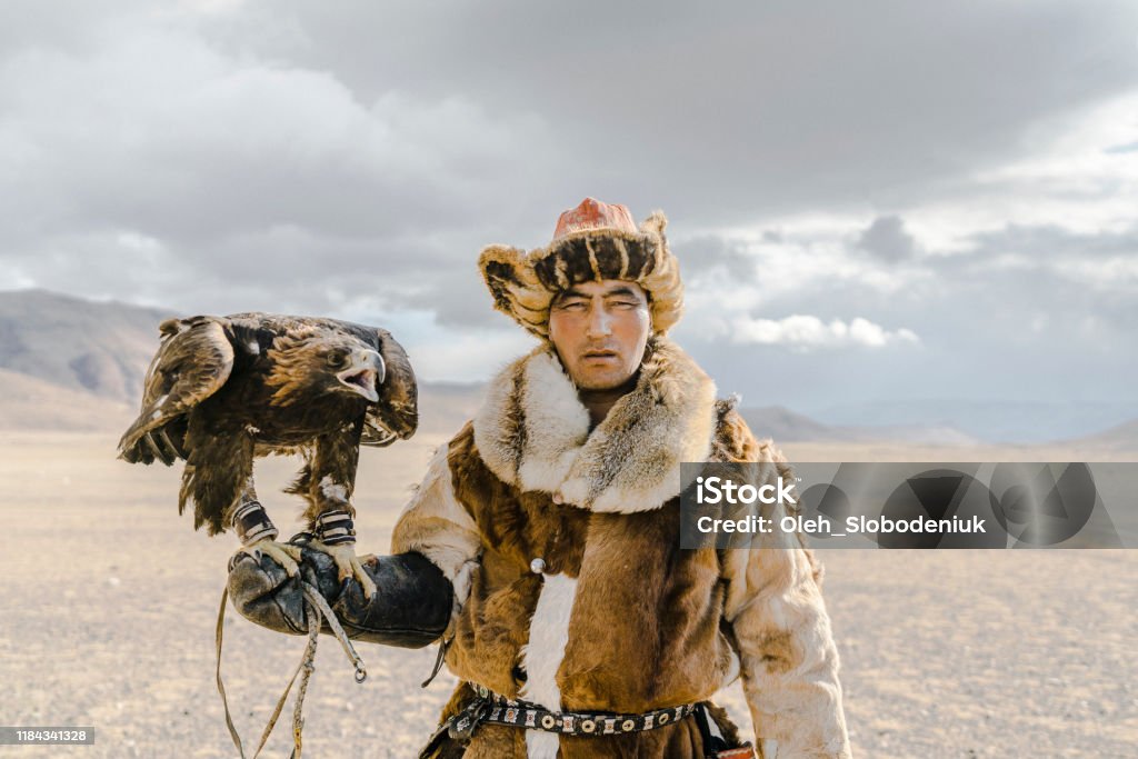 Portrait of eagle hunter standing in desert in Mongolia Independent Mongolia Stock Photo
