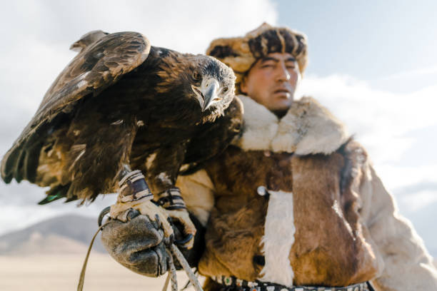 istock Portrait of eagle hunter standing in desert in Mongolia 1184341341